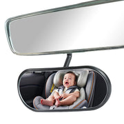 Baby in a car seat reflected in a car mirror
