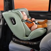 Baby in a green car seat with a visible brand logo, inside a vehicle.