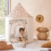 Child playing inside a star-patterned play tent in a room with decorative elements.