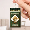 Matchbox keychain with 'The Perfect Match' design held by a hand