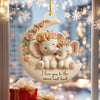Decorative ornament with two elephants on a moon, surrounded by lights and snowflakes.