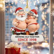 Decorative Christmas ornament of a couple in Santa hats with names 'David' and 'Helen', and text 'Growing old together since 1998'.